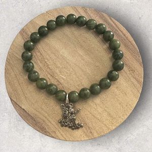 Jade green stone bracelet with sterling silver fairy charm stamped .925 Ireland.